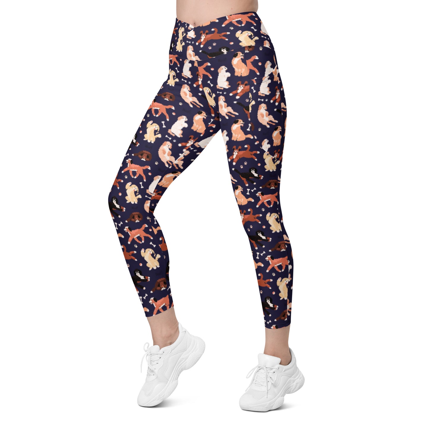 front left view of Pixie and Sherbet’s Puppy Parade Crossover Leggings with a playful dog print, high-waisted crossover waistband, and side pockets.