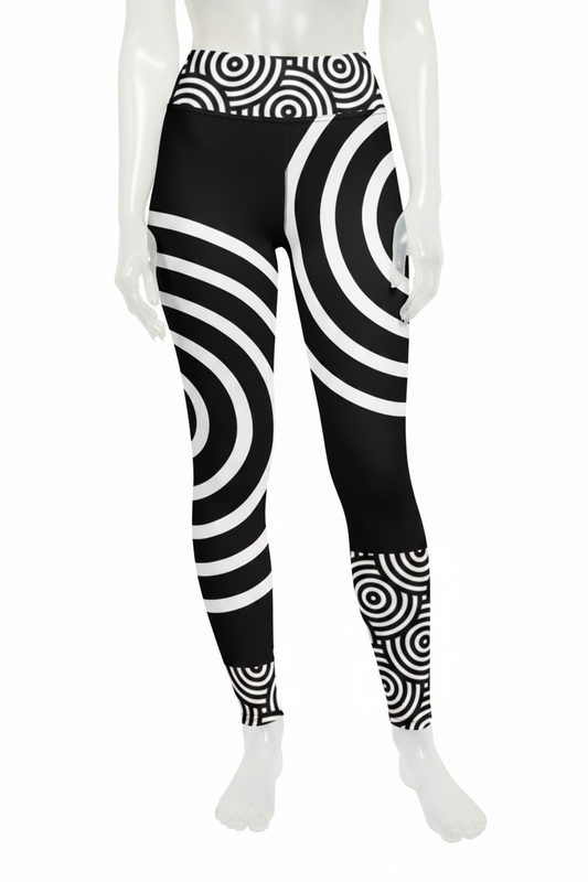 Black and white high-waisted leggings with an optical illusion spiral pattern, shown on a model against a white background.