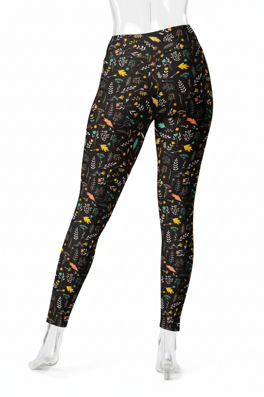 A mannequin modeling a pair of full-length leggings with a black background and a dense multicolor nature print of leaves, birds, and insects, shown from the back against a plain white background.