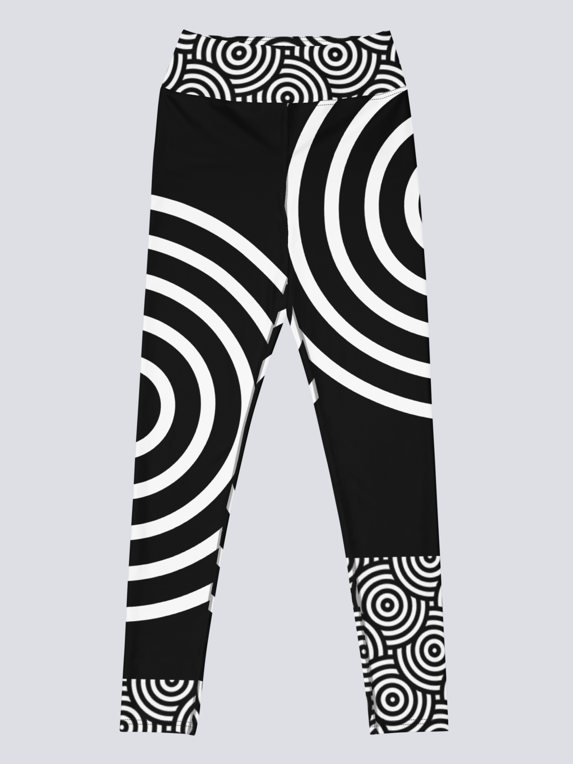 Front view of black high‑waisted Lunar Loops yoga leggings with bold white concentric circle pattern, featuring asymmetrical geometric design for a modern, eye‑catching look.