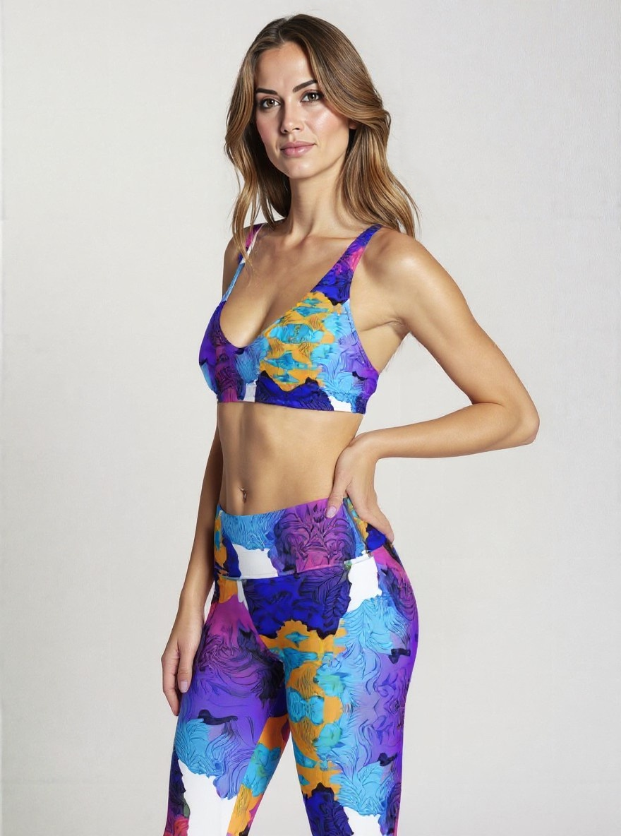 Side view of high-waisted Ocean Mirage Yoga Capri Leggings in ocean-inspired abstract blue, purple, and gold print, shown on a model’s capri-length fit.