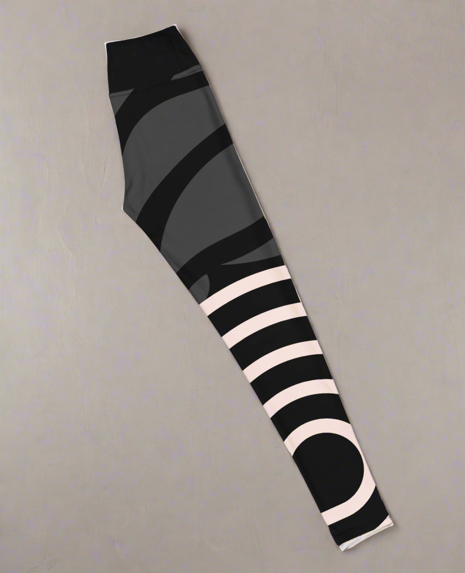 Right side flat lay view of colourful abstract patterned leggings on a grey background