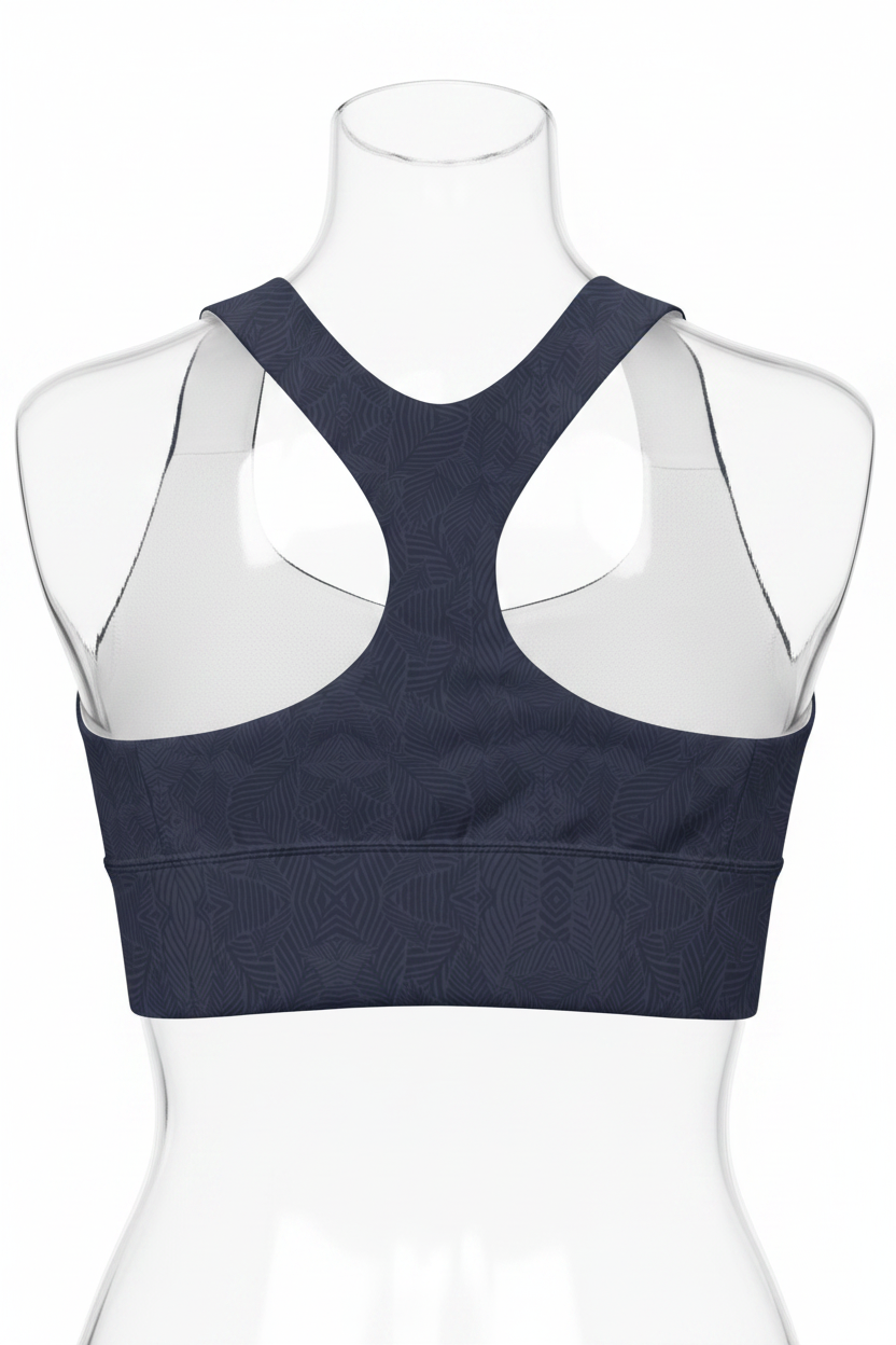 A women's sports bra shown from the back, featuring a dark navy blue body with a subtle tonal geometric pattern and contrasting white inner shoulder panels.