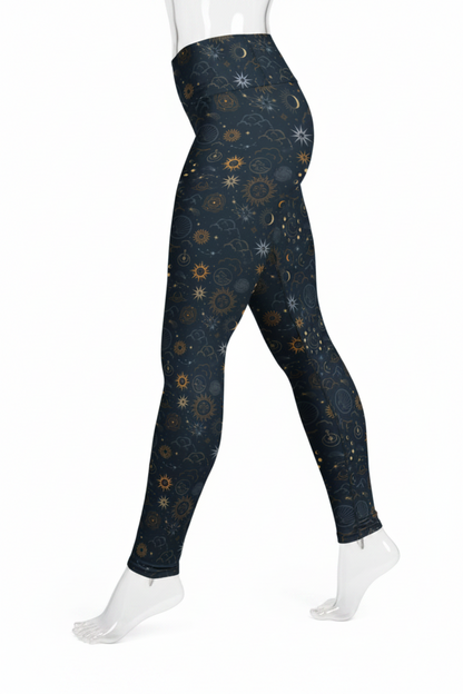 A mannequin in high-waisted leggings with a dark navy blue celestial print featuring stars, moons, and suns in gold, beige, and white, shown against a plain white background.