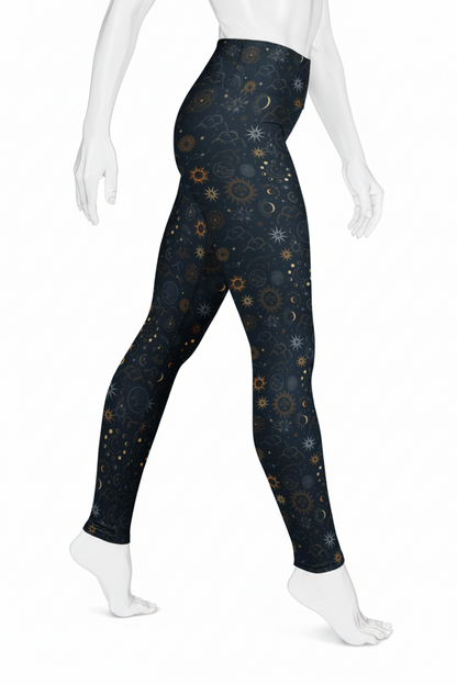 A mannequin modeling high-waisted leggings with a dark navy blue celestial print featuring stars, moons, and suns in gold, white, and light blue, shown against a plain white background.