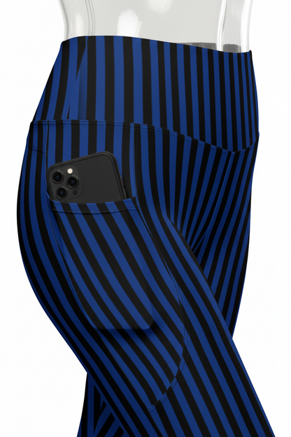 Close-up of a mannequin wearing high-waisted leggings with vertical navy and black stripes, showing a side pocket with a hand inserted, on a white background.