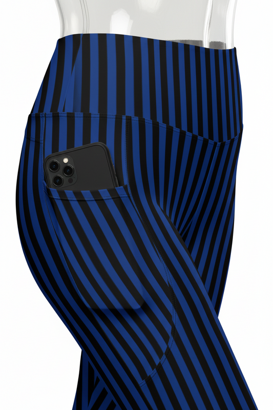 Close-up of a mannequin wearing high-waisted leggings with vertical navy and black stripes, showing a side pocket with a hand inserted, on a white background.