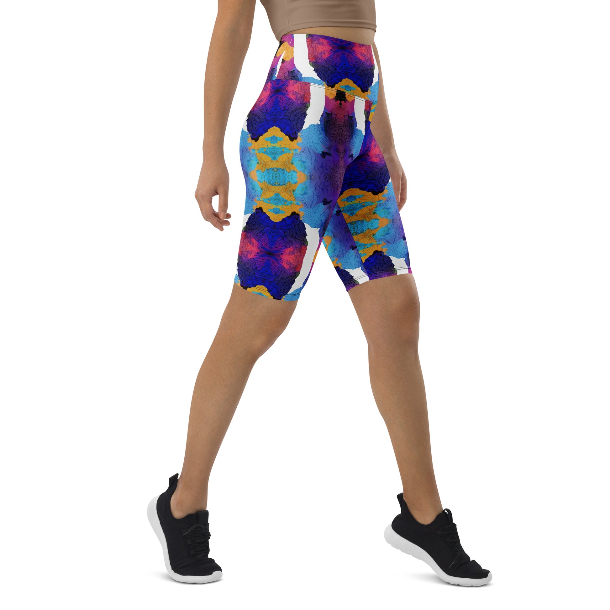 Model walking in Pixie and Sherbet’s Ocean Mirage Biker Shorts, featuring a vibrant multicolour print and high-waisted waistband.