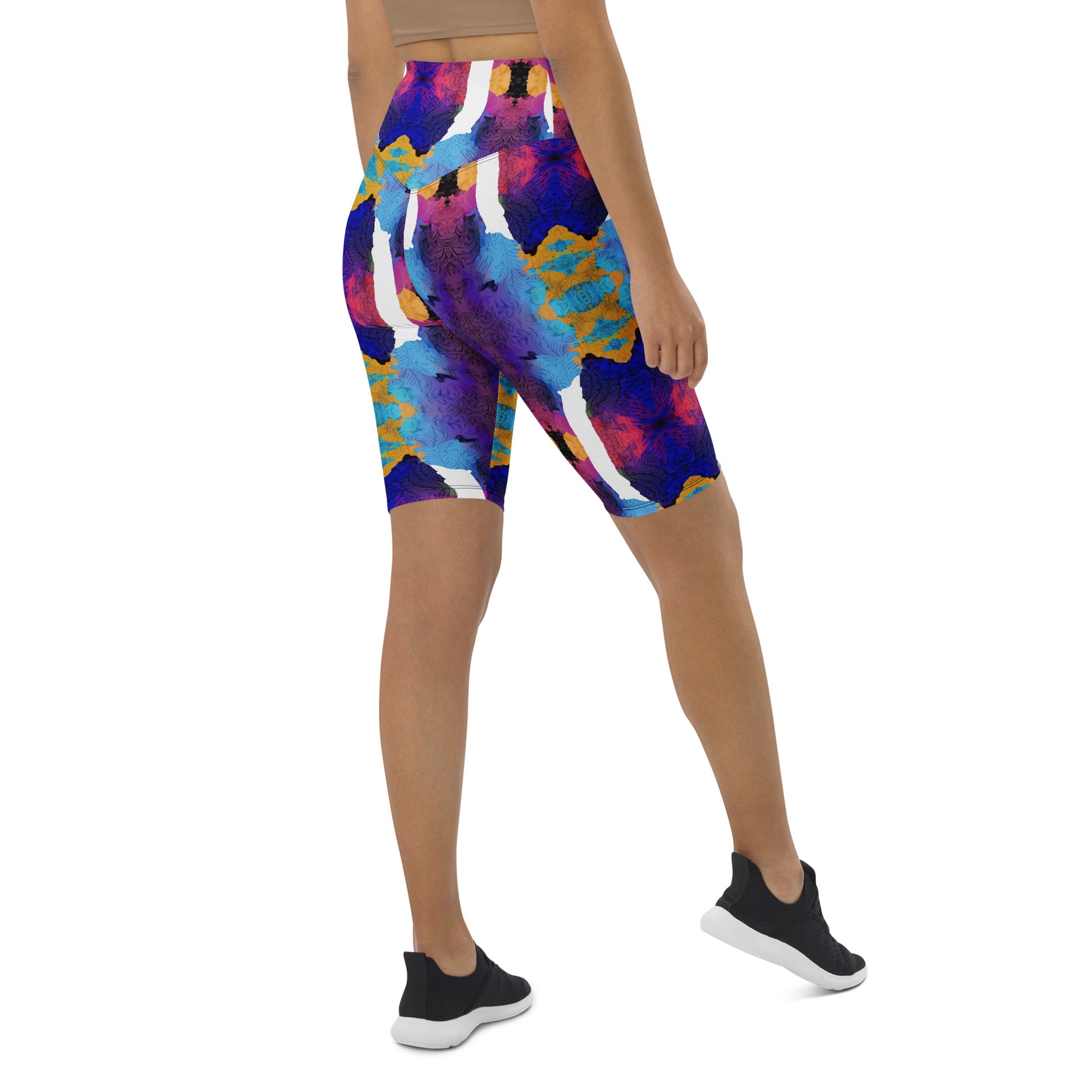 Side view of a model wearing Pixie and Sherbet’s Ocean Mirage Biker Shorts with a vibrant multicolour print and a high-waisted waistband.