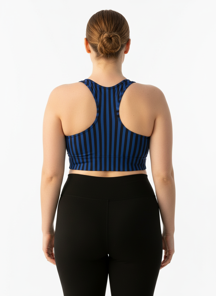 Person wearing a blue and black striped sports bra and black leggings on a white background