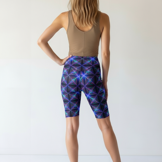 Person wearing a tank top and patterned shorts on a white background
