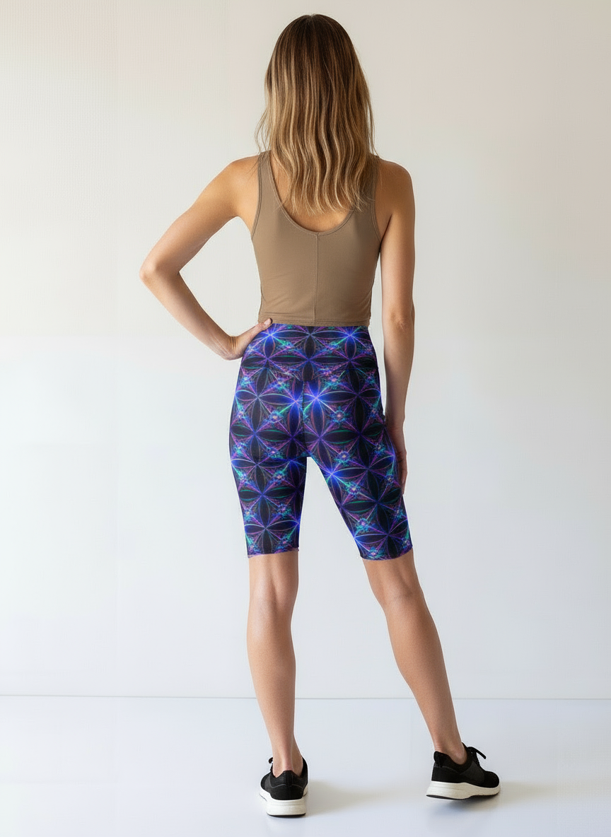 Person wearing a tank top and patterned shorts on a white background
