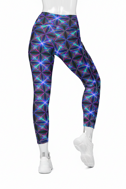 A mannequin wearing high-waisted leggings with a vibrant neon geometric flower pattern in purple, blue, and green on a black base, paired with white sneakers against a plain white background.