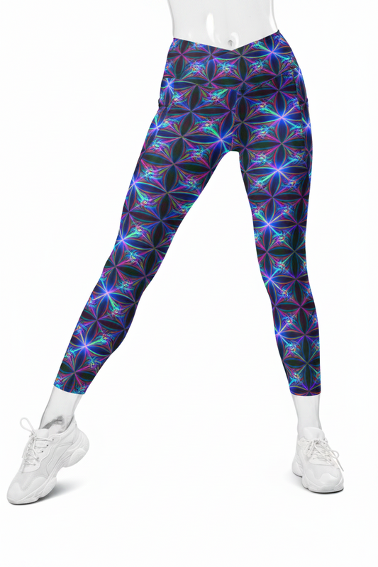 A mannequin wearing high-waisted leggings with a colorful geometric starburst pattern in purple, blue, and pink on a black background, paired with white sneakers against a plain white studio background.