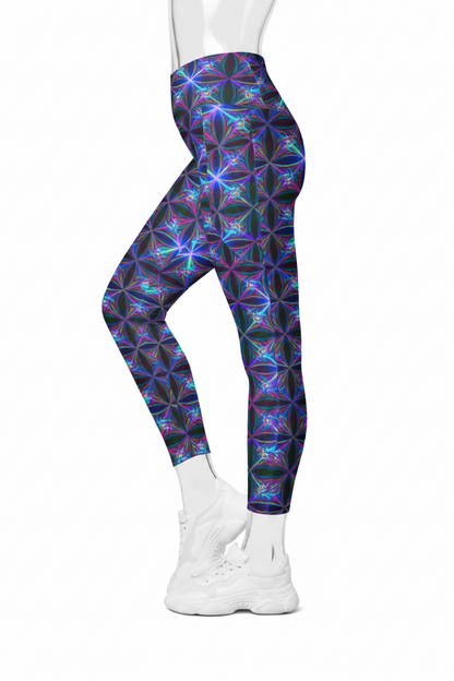 A mannequin wearing high-waisted leggings with a vibrant, multicolored geometric kaleidoscope pattern in purple, blue, and pink on a black base, paired with white sneakers against a plain white background.