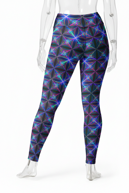 A mannequin modeling high-waisted leggings with a vibrant, repeating geometric flower pattern in purple, blue, and teal on a black background, shown from the waist down against a plain white studio backdrop.