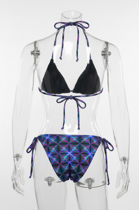 Two-piece string bikini set on a white background, featuring a solid black triangle top and matching low-rise bottoms with a vibrant purple, blue, and pink geometric flower pattern.