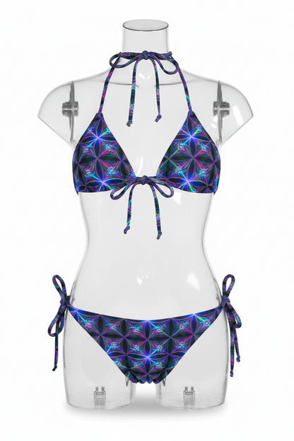 A two-piece string bikini set featuring a vibrant, multicolored kaleidoscopic geometric pattern on a black base, shown against a plain white background.