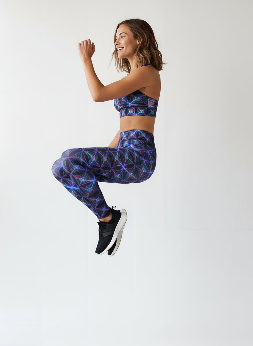 Woman wearing a colorful geometric patterned sports bra and leggings on a white background