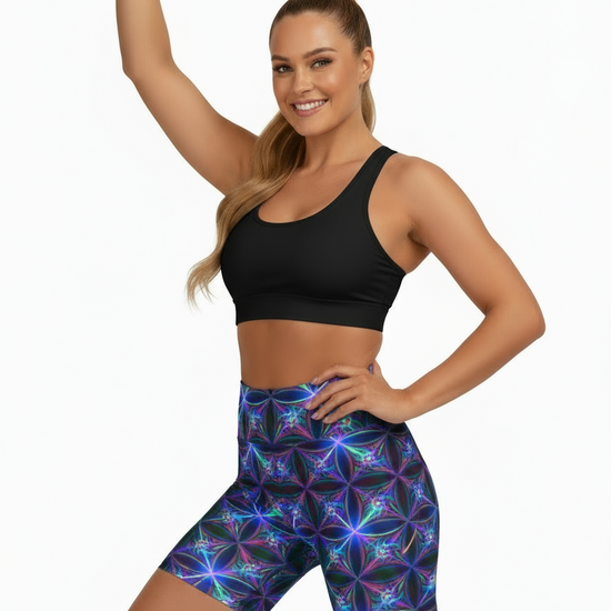 Woman wearing a colorful sports bra and shorts set on a white background