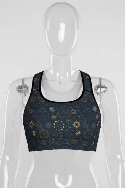 A mannequin wearing a dark navy blue sports bra with a celestial pattern of gold and light blue suns, moons, and stars, shown against a plain white background.