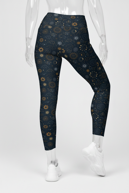A mannequin wearing high-waisted leggings with a dark navy blue celestial print of stars, suns, and moons, paired with white sneakers against a plain white background.