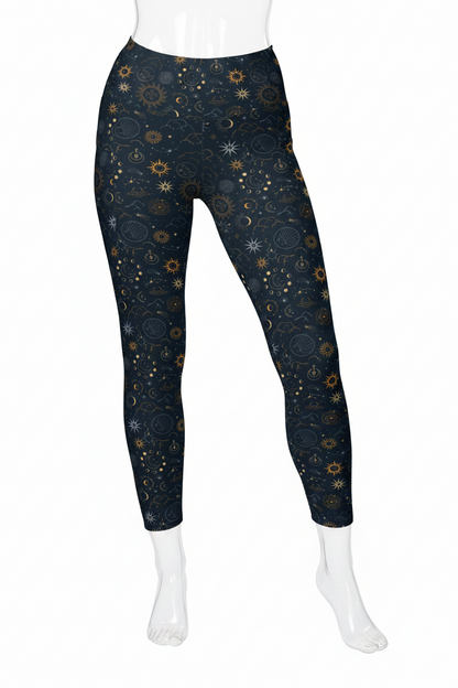 A mannequin modeling high-waisted leggings with a dark navy blue celestial print featuring gold and light blue stars, suns, and crescent moons, paired with white sneakers against a plain white background.