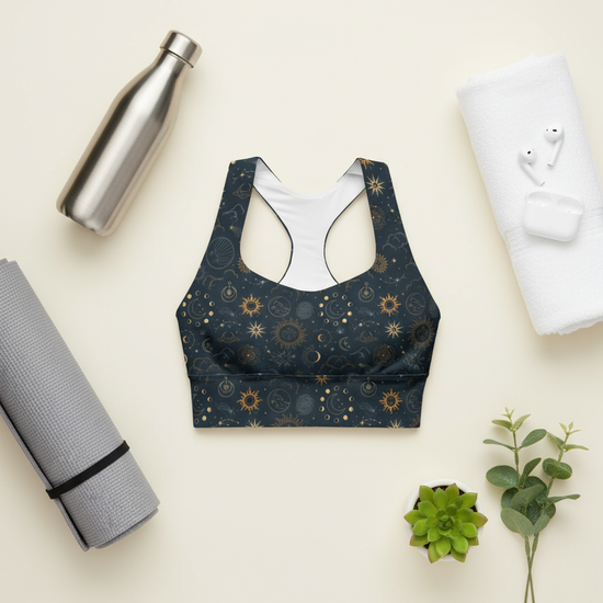 Patterned sports bra with a water bottle, yoga mat, and plant on a light background