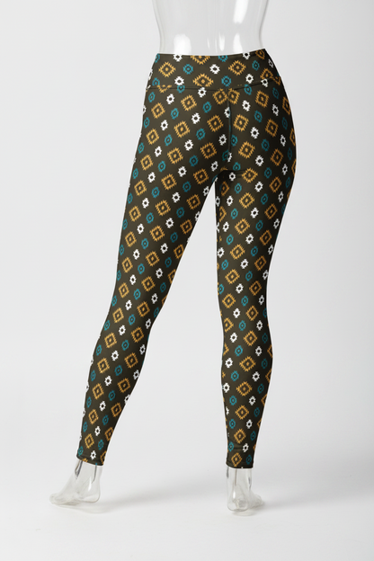 A mannequin modeling high-waisted leggings with a repeating geometric diamond pattern in brown, teal, white, and black, shown from the waist down against a plain white background.