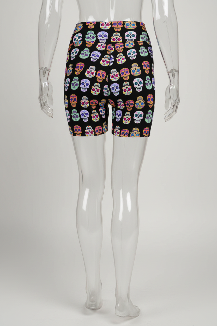 A mannequin modeling black biker shorts with a colorful sugar skull pattern, shown from the back against a plain white background.