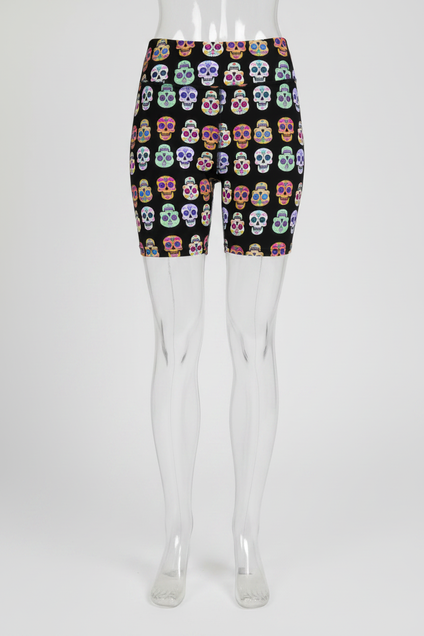 A mannequin wearing high-waisted black biker shorts with a colorful sugar skull pattern, shown from the waist down against a plain white background.