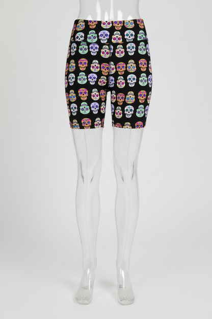 A mannequin wearing high-waisted black biker shorts with a colorful sugar skull pattern, shown from the waist down against a plain white background.