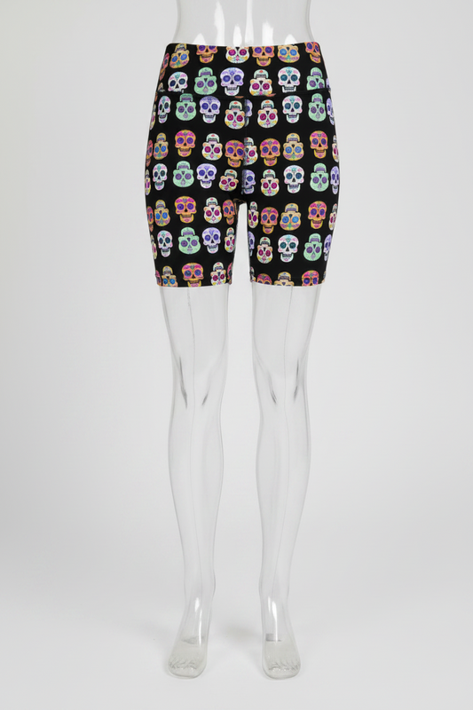 A mannequin wearing high-waisted black biker shorts with a colorful sugar skull pattern, shown from the waist down against a plain white background.