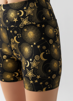 Black shorts with gold celestial pattern on a white background