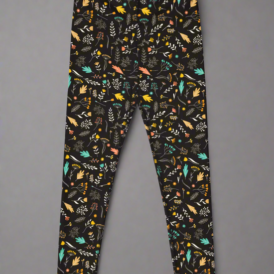 Front view of leggings with colourful floral pattern on a black background.