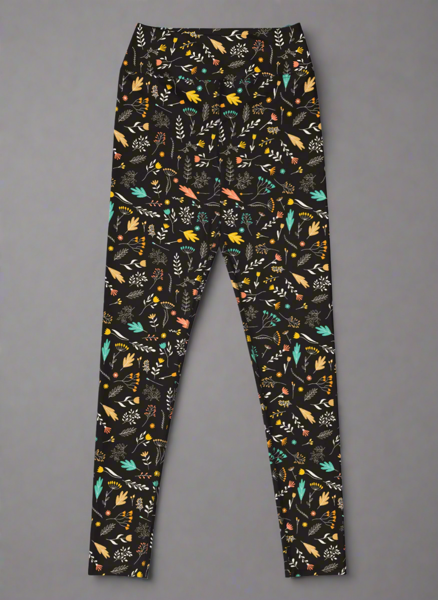 Front view of leggings with colourful floral pattern on a black background.