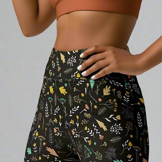Person wearing a patterned Harvest Sky Yoga leggings with a plain background