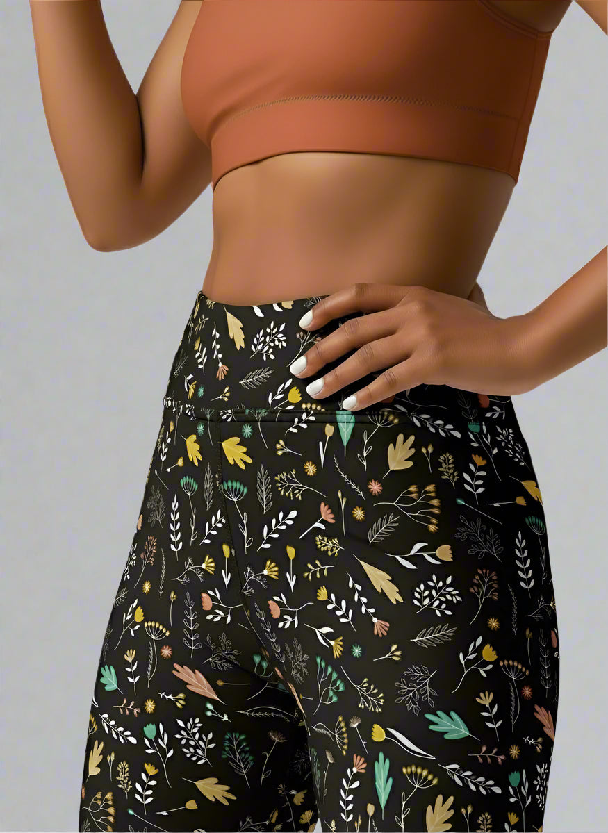 Person wearing a patterned Harvest Sky Yoga leggings with a plain background