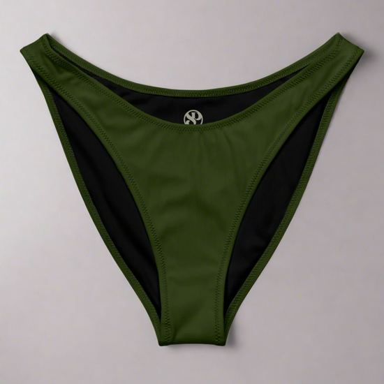 Flat lay of Jade Muse V‑Cut Bikini Bottom in rich jade green against light background to showcase flattering high‑leg cut and smooth luxe fabric.