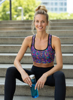 Woman in athletic wear holding a water bottle on steps outdoors