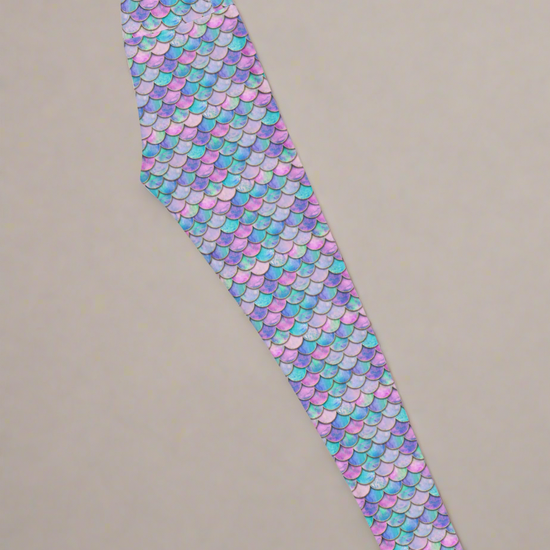 Right side of Lumina Siren Yoga leggings with mermaid scale pattern on a light grey background