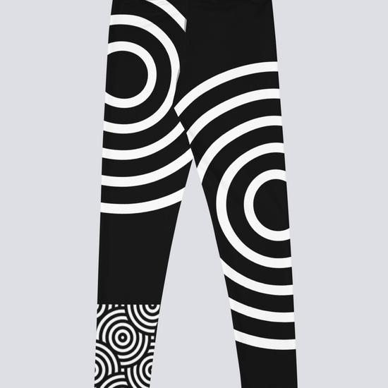 Back view of black high‑waisted Lunar Loops yoga leggings with bold white concentric circle pattern, featuring asymmetrical geometric design across legs and waistband for a striking, modern look.