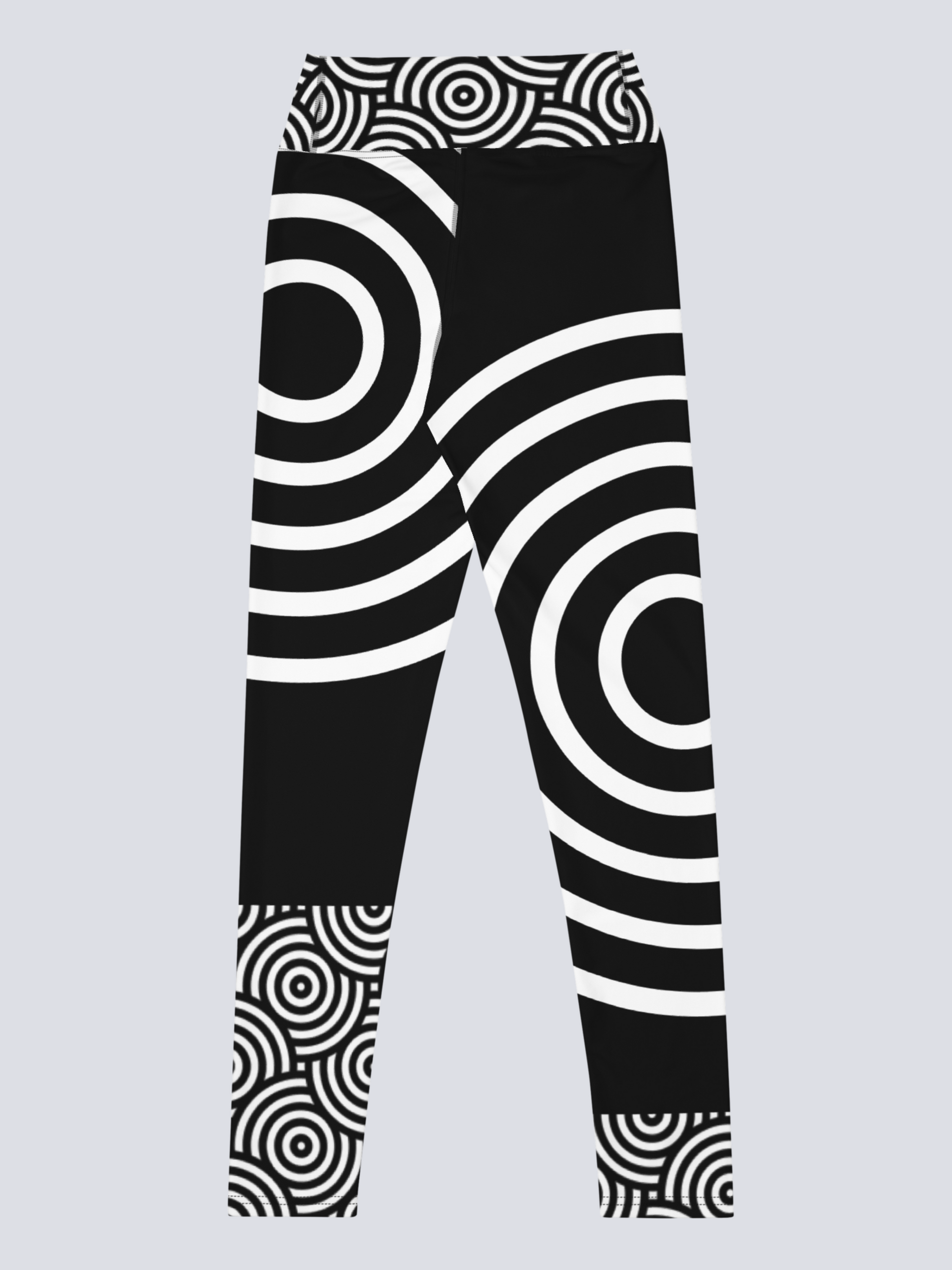 Back view of black high‑waisted Lunar Loops yoga leggings with bold white concentric circle pattern, featuring asymmetrical geometric design across legs and waistband for a striking, modern look.