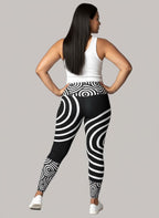 Person wearing black and white patterned leggings on a gray background