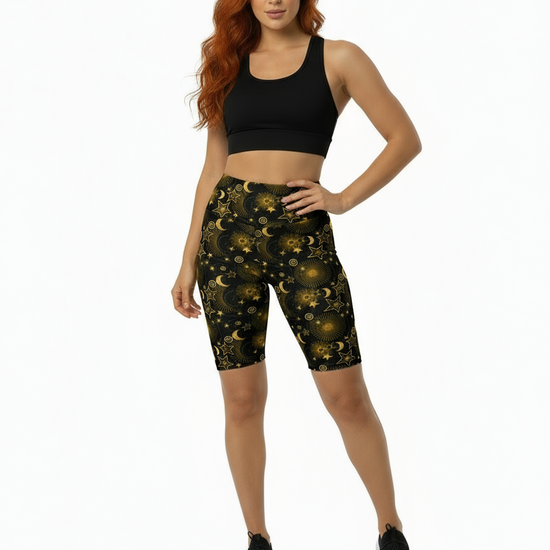 Woman wearing black sports bra and patterned shorts on a white background