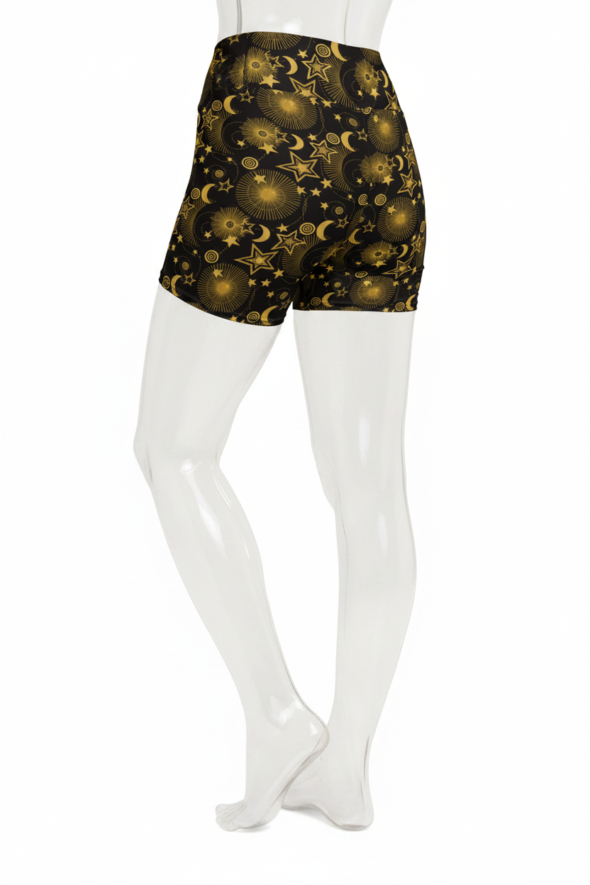 A mannequin wearing high-waisted black shorts with a gold celestial print of stars, moons, and planets, shown from the waist down against a plain white background.