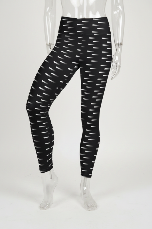 Black high-waisted leggings with a white geometric dash pattern, shown on a mannequin against a plain white background. 