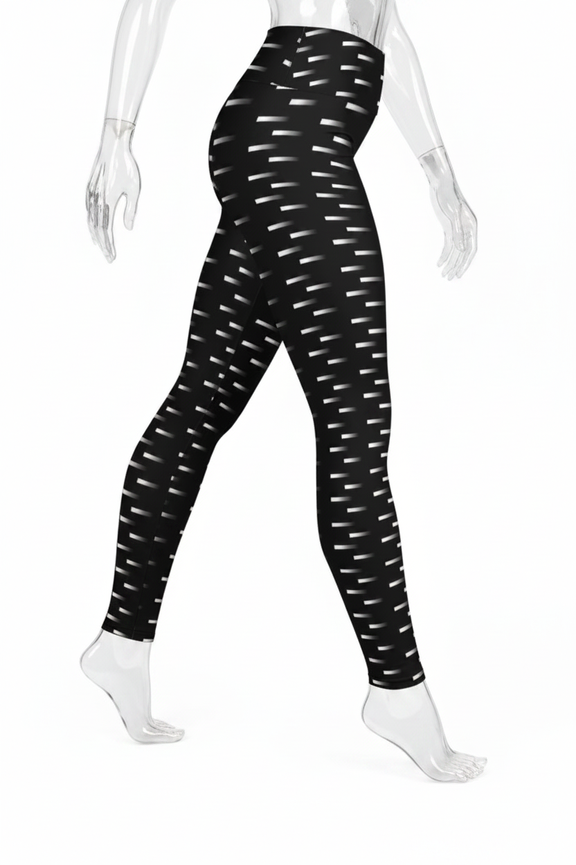 Black high-waisted leggings with a white dash pattern, shown on a mannequin from the waist down against a white background.