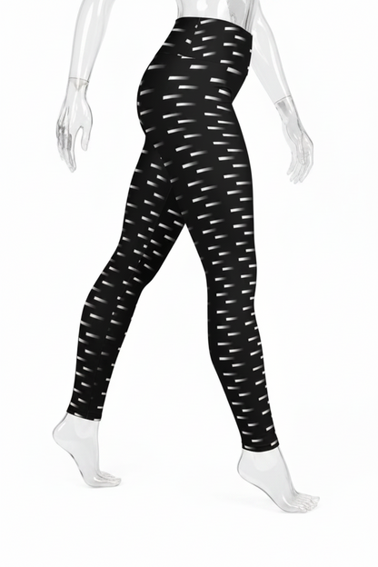 Black high-waisted leggings with a white dash pattern, shown on a mannequin from the waist down against a white background.
