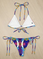 Colorful bikini set with a tie-dye pattern on a beige background
